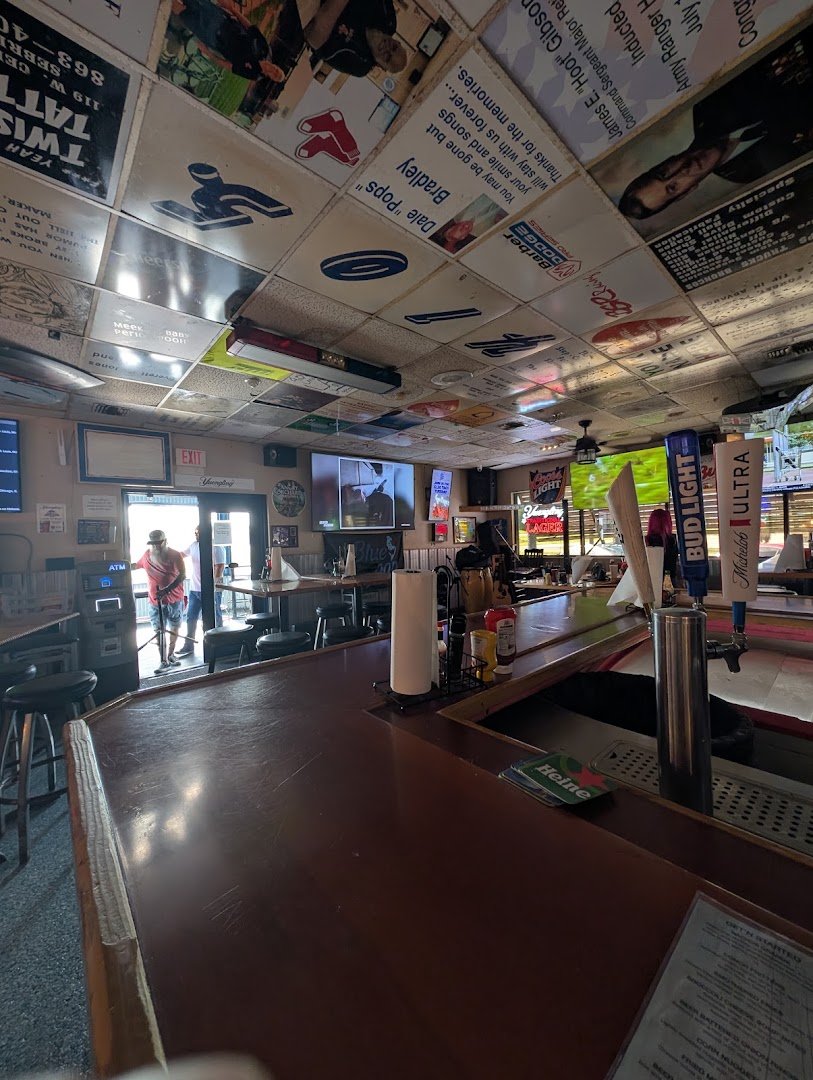 Sports screens above a neighborhood bar.